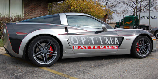 Signage vinyl tastefully applied to a grey car, featuring promotional messages, brand logos, or custom designs, adding a dynamic and eye-catching element to the vehicle's appearance. | © Scandraft AB